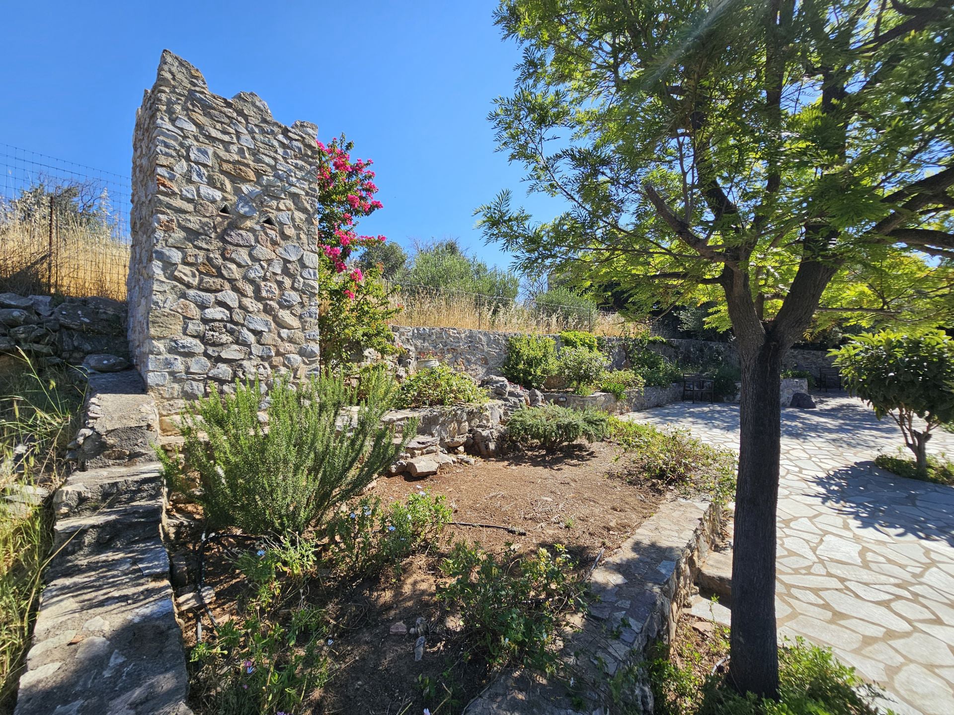 The beautiful garden with store tower behind of the houses